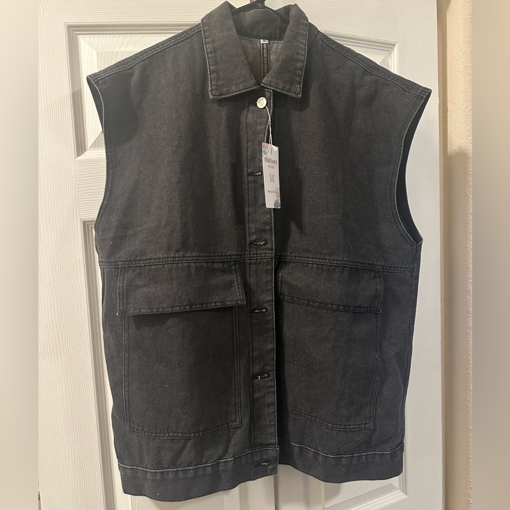 Black sleeveless jean jacket.